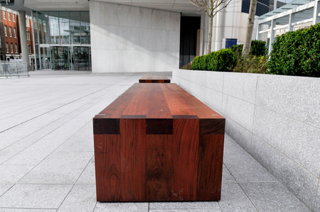 bench from a low angle in a public city spaceの写真素材
