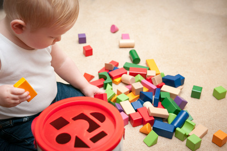 baby playing with blocks and sorting shapesの写真素材