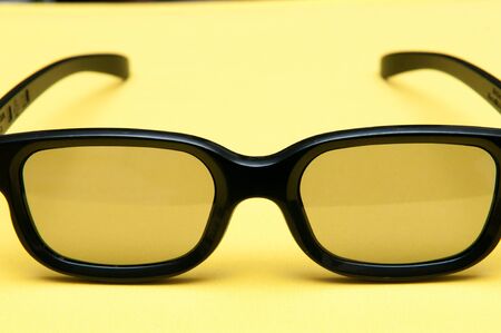 Glasses with black frame on yellow background