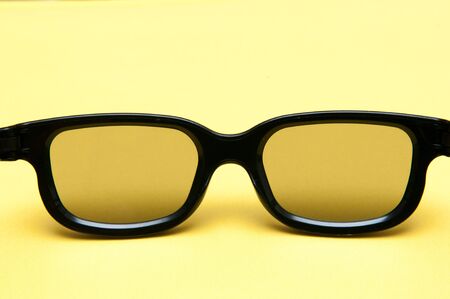 Glasses with black frame on yellow backgroundの写真素材
