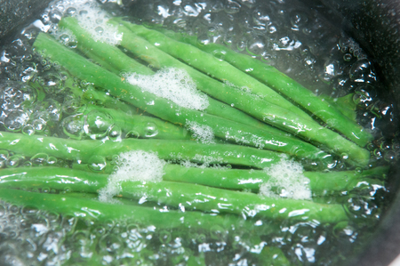 Fresh green beans cooking in waterの写真素材