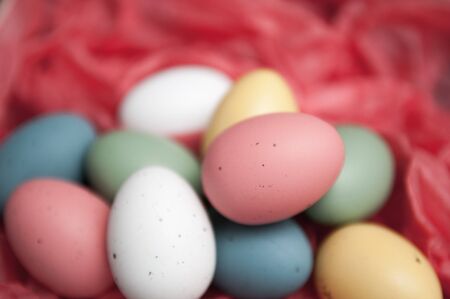 Easter eggs piled up on a red backgroundの写真素材