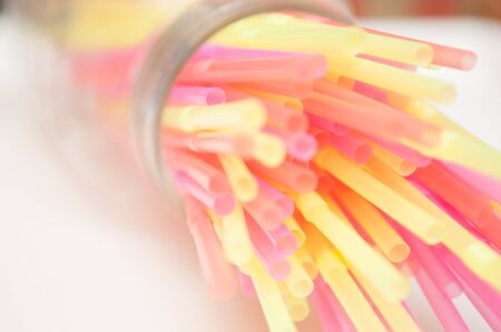 Fun party background of brightly coloured drinking strawsの写真素材