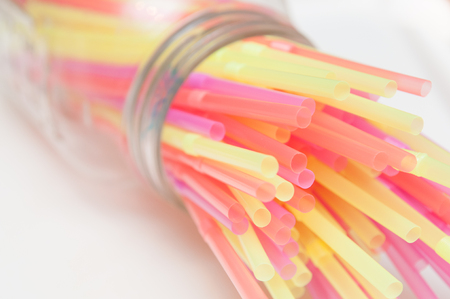Fun party background of brightly coloured drinking strawsの写真素材