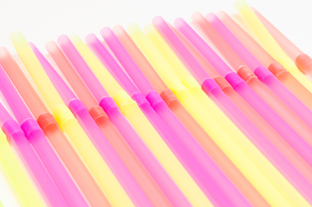Fun party background of brightly coloured drinking strawsの写真素材