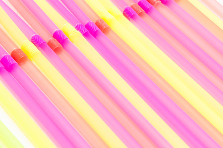 Fun party background of brightly coloured drinking strawsの写真素材