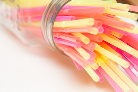 Fun party background of brightly coloured drinking strawsの写真素材