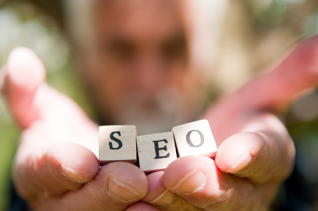Male hand holding SEO lettering for website optimization and increase trafficの写真素材