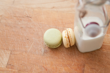 milk and cookies on a wooden table with vintage milk bottleの写真素材