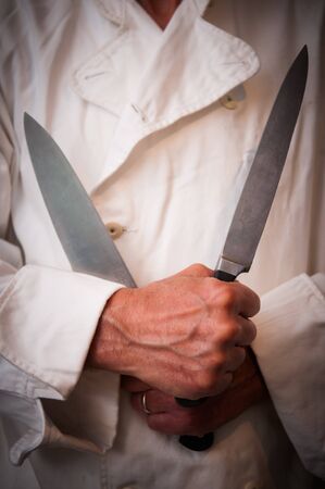chef using knife held in front of himの写真素材