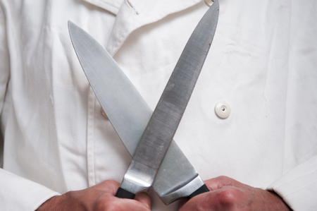 chef using knife held in front of himの写真素材