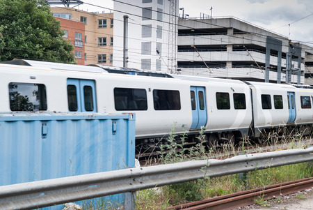 Train on a railway line through a city background