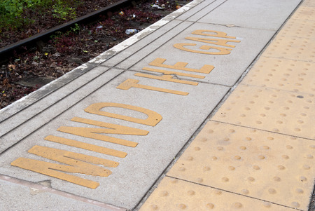 Platform edge at the train station with safety warning