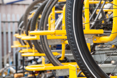 bikes lined up in the store in yellow rackの写真素材