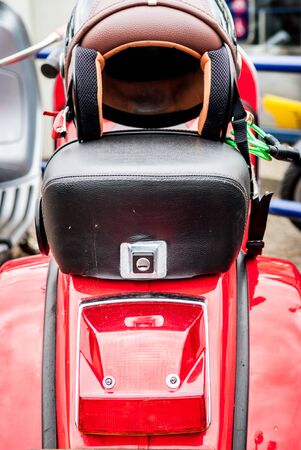 Retro style red motor scooter with crash helmetの写真素材
