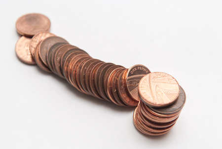 British one penny coins in a fallen pile