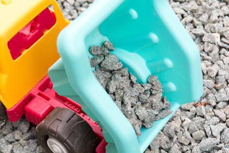 toy tipper truck moving gravel building materialsの写真素材