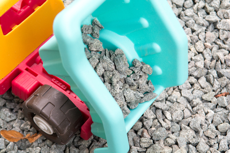 toy tipper truck moving gravel building materialsの写真素材