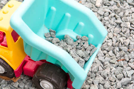 toy tipper truck moving gravel building materialsの写真素材