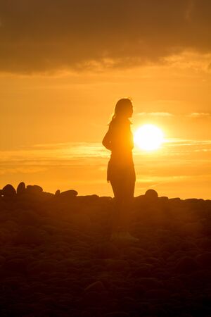 Yoga Woman doing yoga pose outside in sunsetの写真素材
