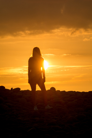 Yoga Woman doing yoga pose outside in sunsetの写真素材