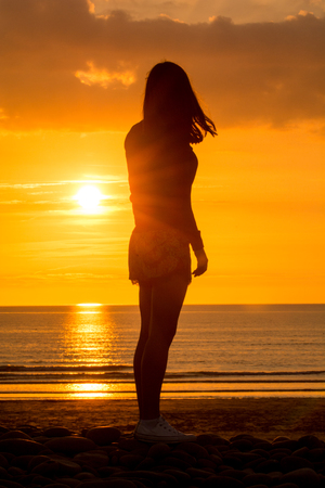 Yoga Woman doing yoga pose outside in sunsetの写真素材