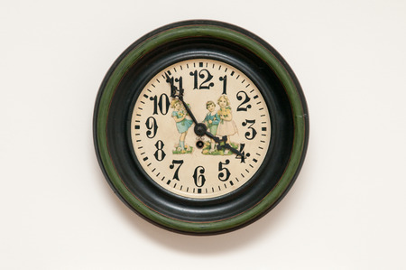 Vintage wall clock mounted on a plain white wallの写真素材