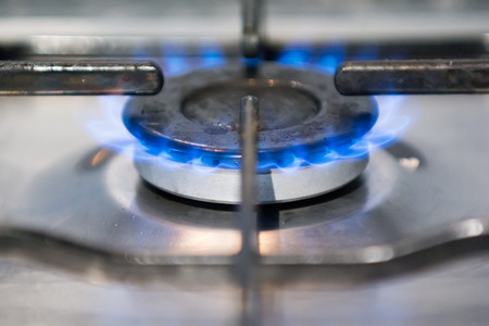 Blue gas flame on the hob of a home ovenの写真素材