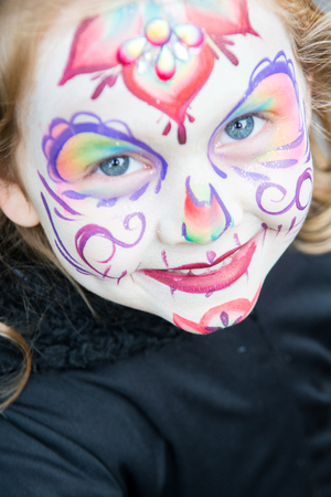 Young girl with beautiful but scary face paintの写真素材