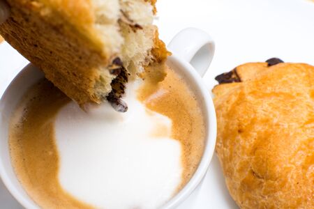 breakfast food on a plate, cappuccino coffee and chocolate croissantの写真素材