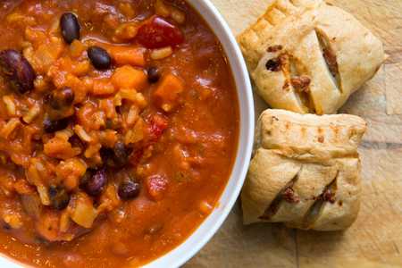 Warming bean and rice soup in a bowl with breadの写真素材