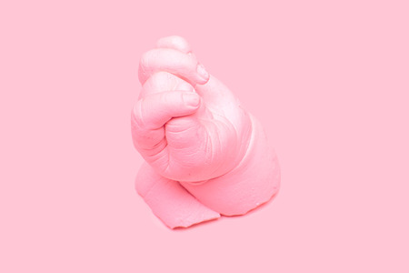Pink ceramic plaster cast of a hand, art sculpture in pinkの写真素材