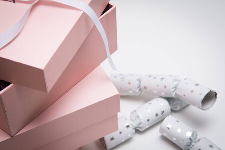 Christmas gift wrapped in pink boxes and ribbon on whiteの写真素材