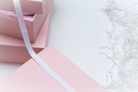 Christmas gift wrapped in pink boxes and ribbon on whiteの写真素材