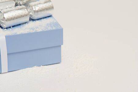 Blue Christmas present in a gift box with snowの写真素材