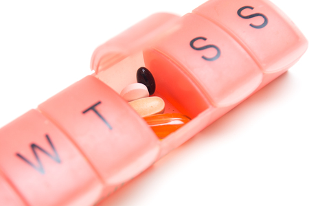Pill box with medicine tablets to organise daily dose of medicineの写真素材