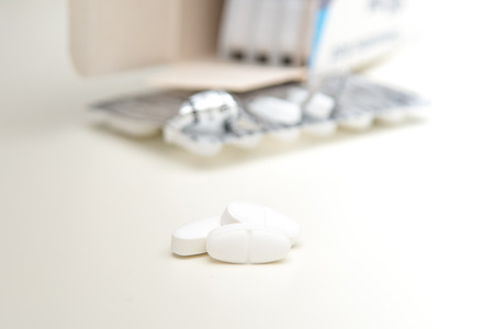 White tablets isolated on white with some pills in foreground
