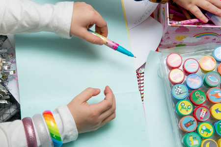 Children using art equipment to draw and make pictures, close up of handsの写真素材