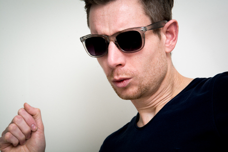 Man dancing and wearing shades on whiteの写真素材