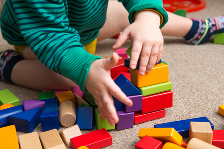 Child playing with building blocks learning new skillsの写真素材