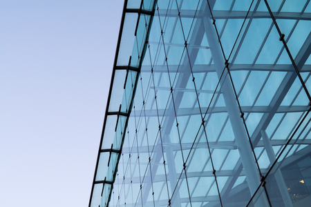 Office building with glass exterior on a clear dayの写真素材