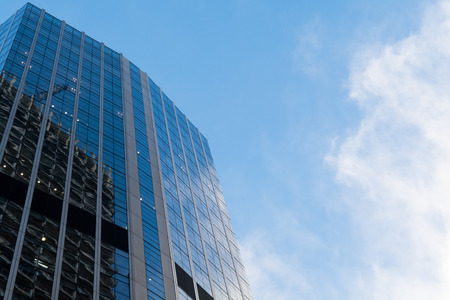 Office building with glass exterior on a clear dayの写真素材