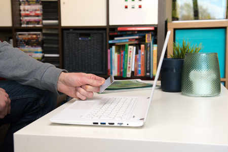 Hand holding credit card, online shopping on laptop computerの写真素材