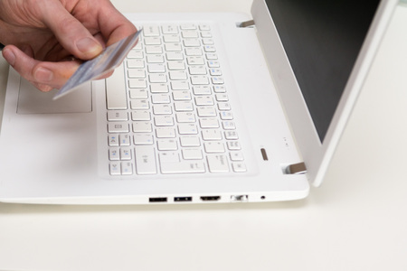 Hand holding credit card, online shopping on laptop computerの写真素材