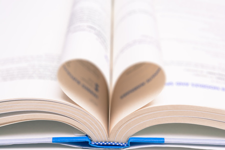 Love learning. Open book with folded pagesの写真素材