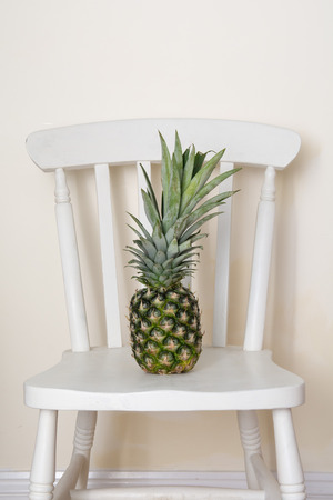 Relaxation abstract concept, pineapple in a chairの写真素材