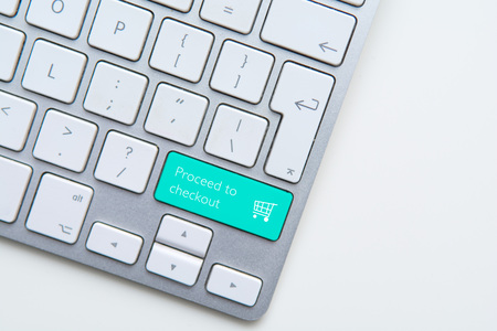 Checkout button on computer keyboard with shopping cartの写真素材
