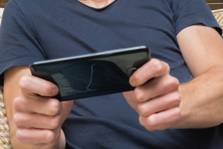 man using mobile phone to play a gameの写真素材