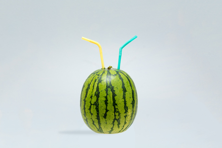 Watermelon with two straws to share with a friendの写真素材