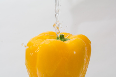 Whole fresh yellow pepper vegetable isolated on whiteの写真素材